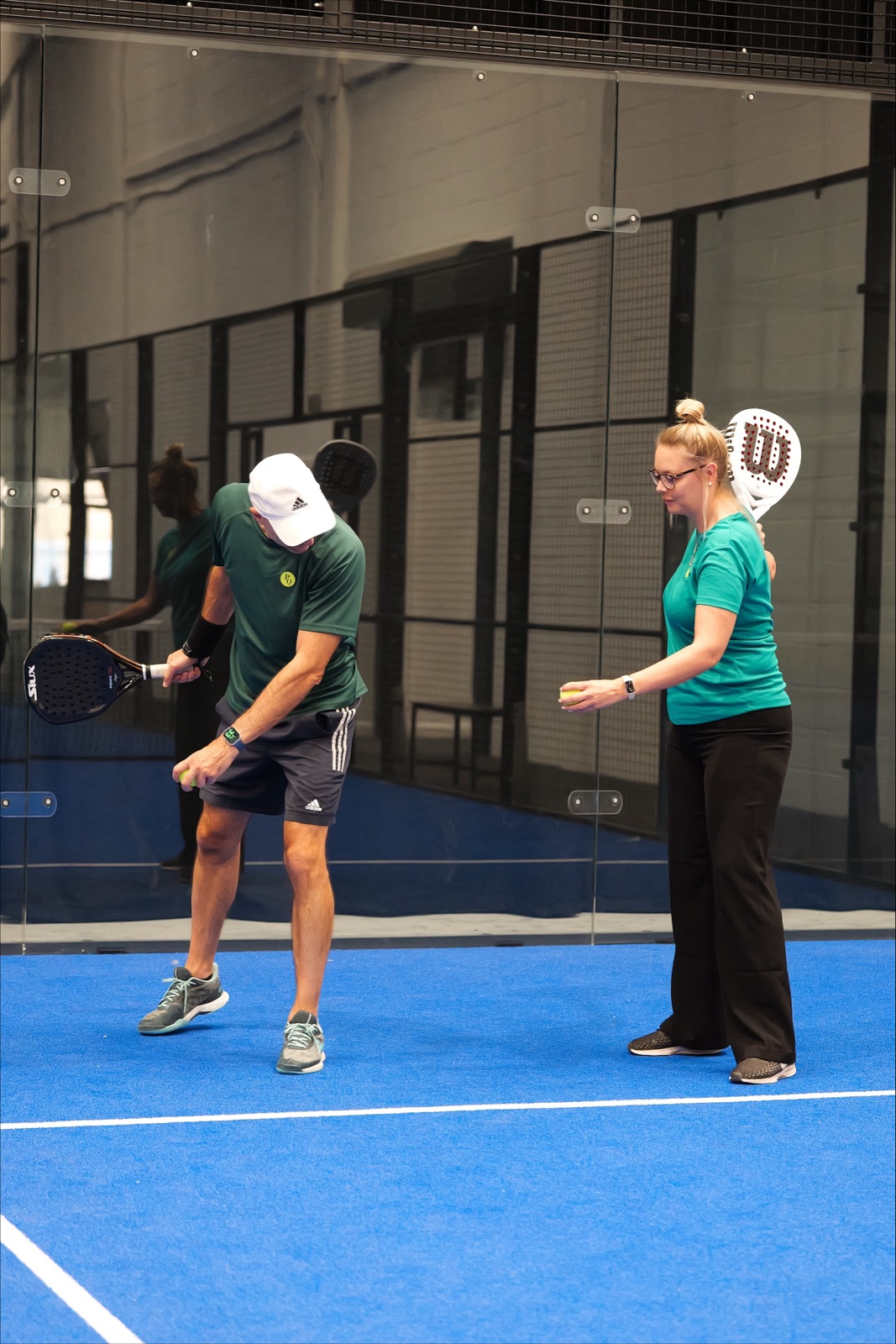 A coach working with a player at Padel Quarter