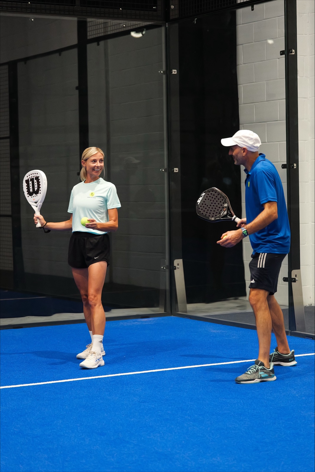 A coach working with a player on court