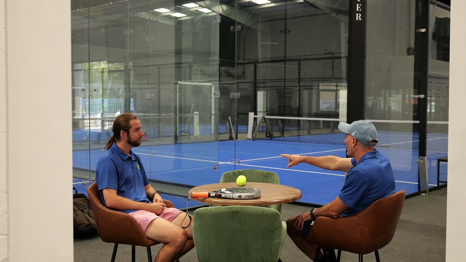 Players relaxing in the lounge beside the courts
