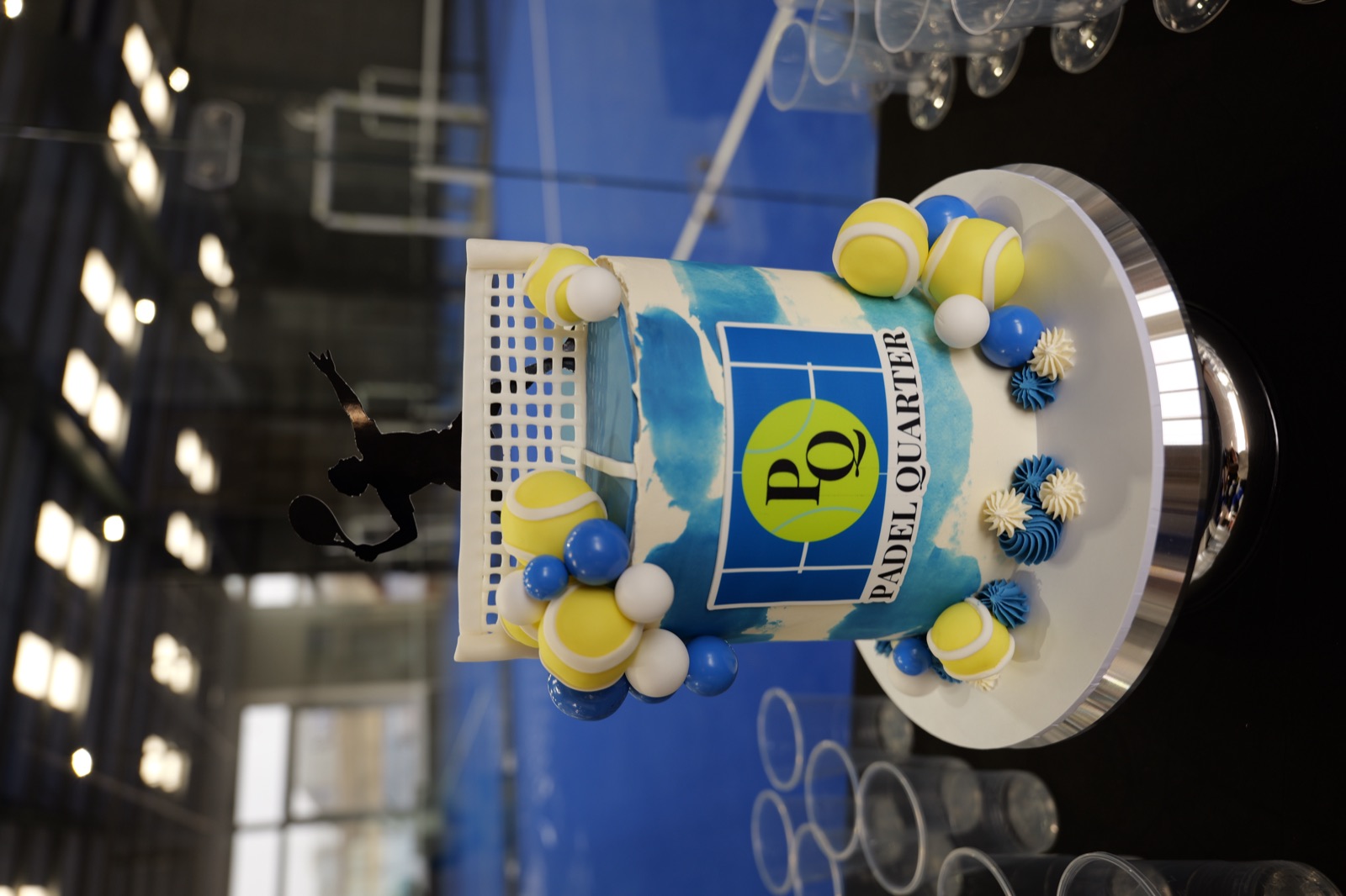 The opening-day cake, courts behind it