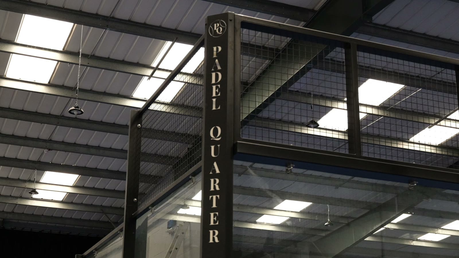The Padel Quarter sign above the courts